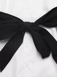 White shirt with a large black bow on a white background
