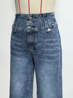 Blue jeans on a mannequin with a white background