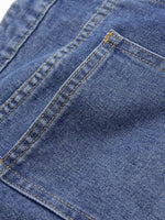Close-up of a blue denim fabric with stitching details