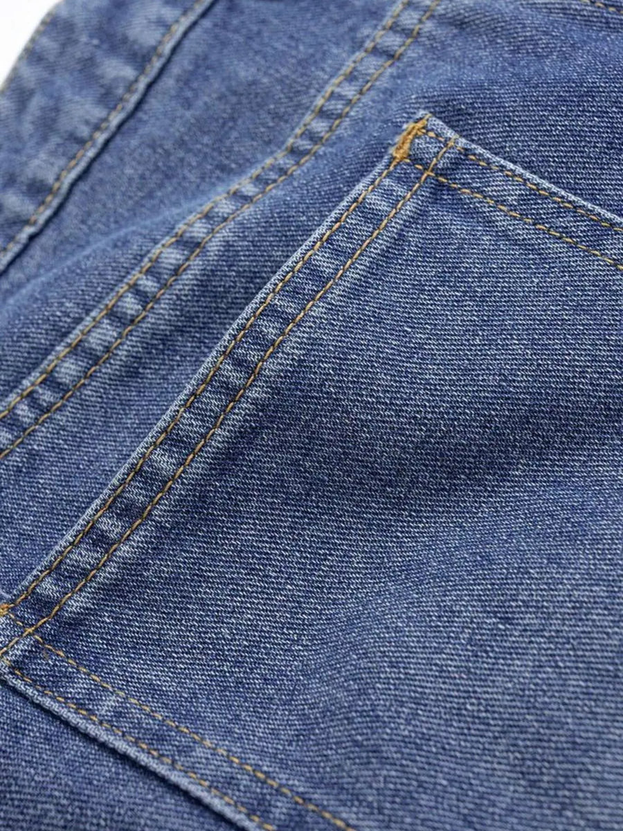 Close-up of a blue denim fabric with stitching details