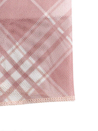 Close-up of a pink checkered fabric with a white background
