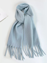 Light blue scarf with fringes on a white background