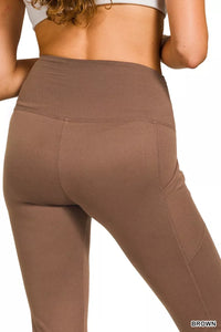 Brown leggings worn by a person on a white background