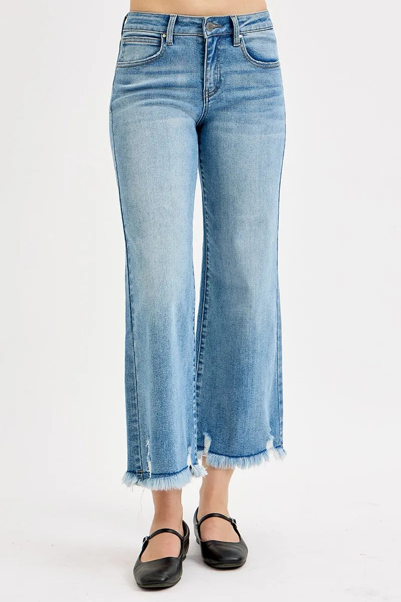 Light blue jeans worn by a person on a white background