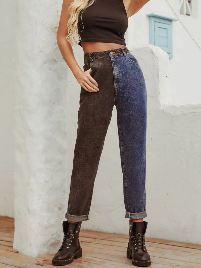 Person wearing a two-tone denim outfit with a white wall background