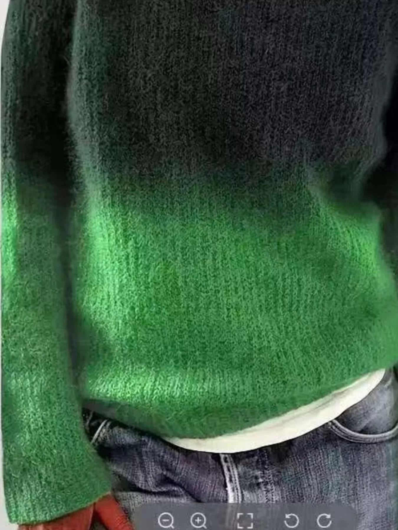 Green and black gradient sweater worn by a person, with a focus on the sweater's color transition.
