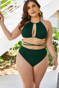 Woman wearing a green bikini set with a white background