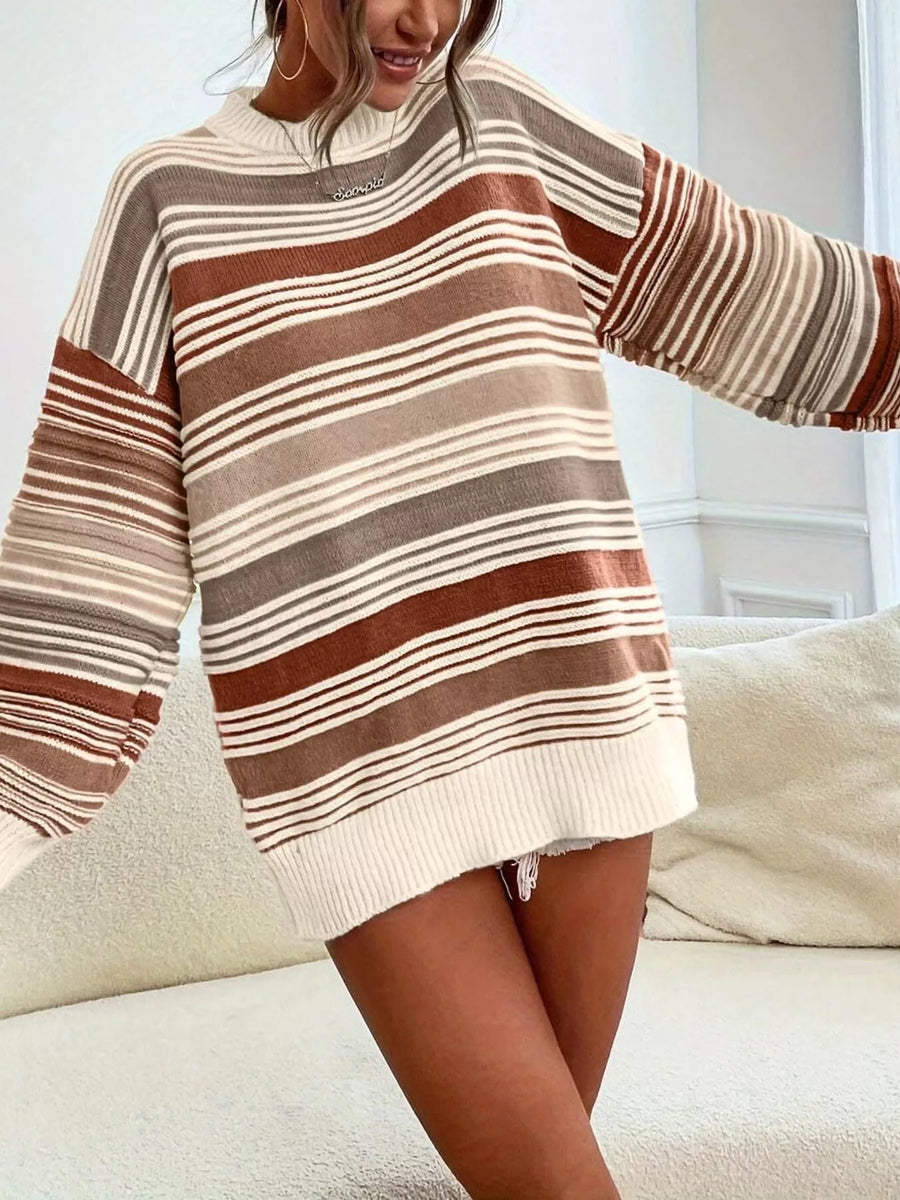 Person wearing a striped sweater with horizontal brown, beige, and white stripes on a light background.