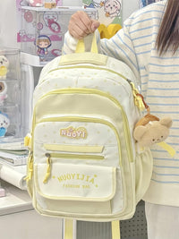 Light yellow backpack with 'NUOYILIA' branding held by a person in a store setting.