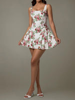 Woman wearing a floral dress on a plain background
