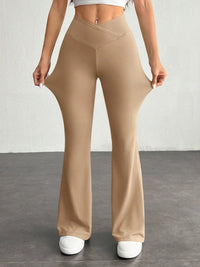 Beige flared pants worn by a person on a plain background