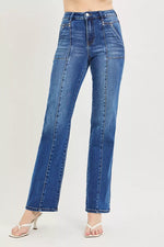 Blue jeans worn by a person on a light gray background