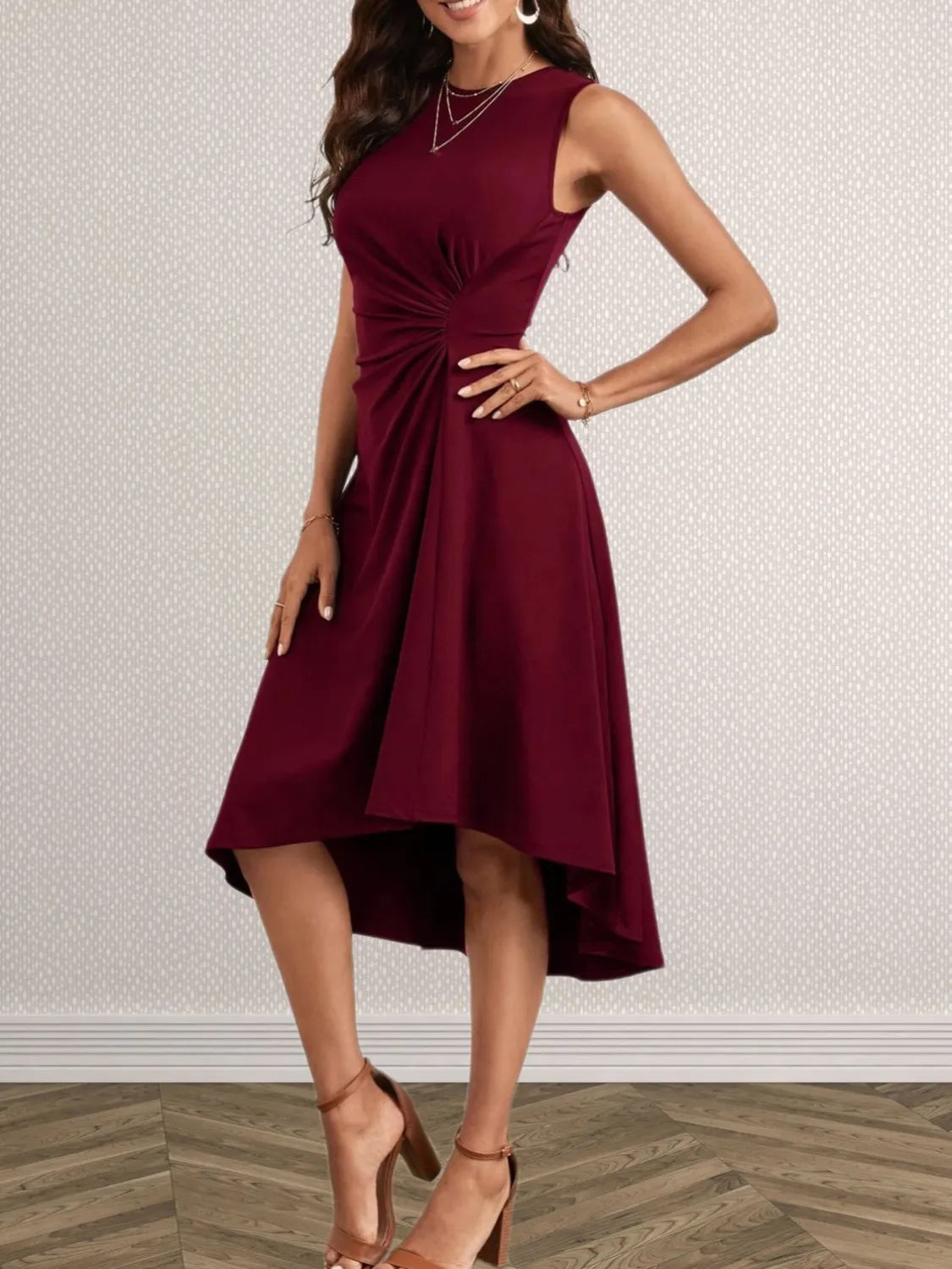 Woman wearing a burgundy dress with a textured wall background