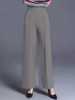 Gray wide-leg pants worn by a person on a gray background
