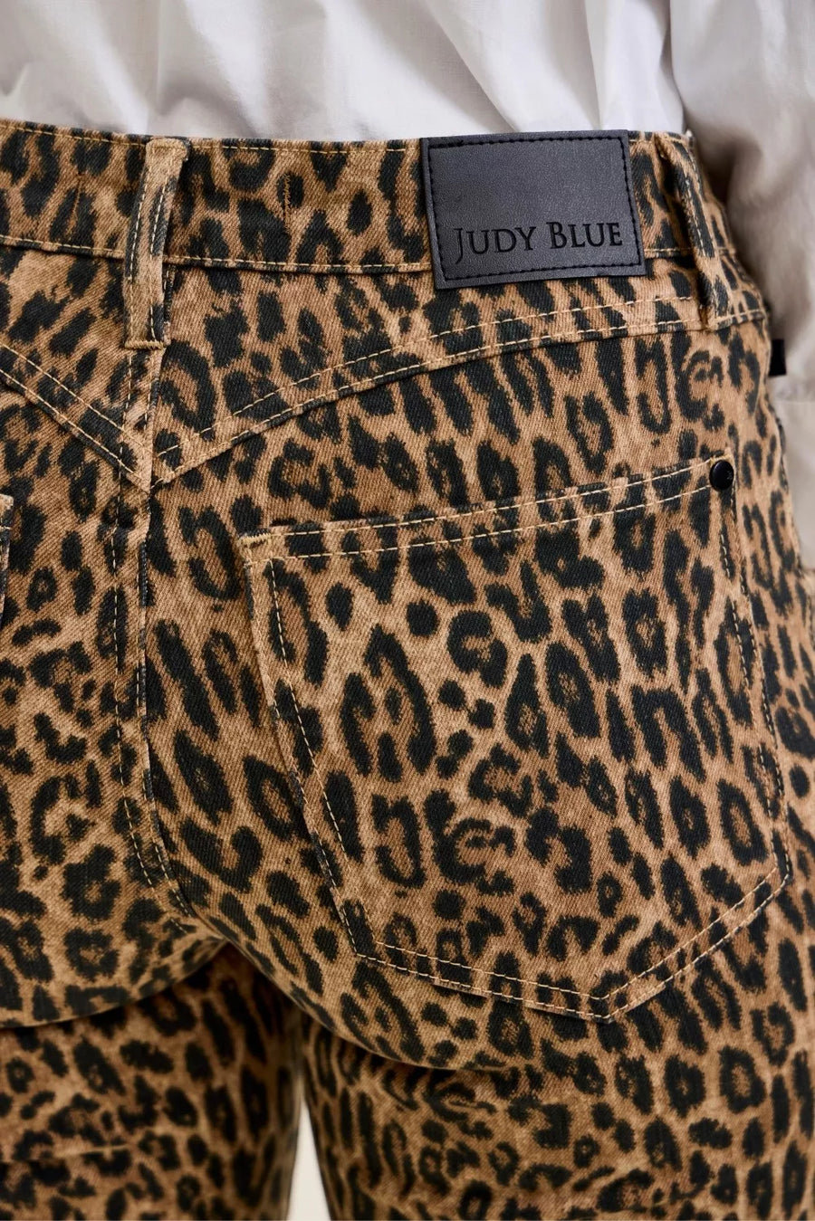 Leopard print pants with a Judy Blue label on a plain background