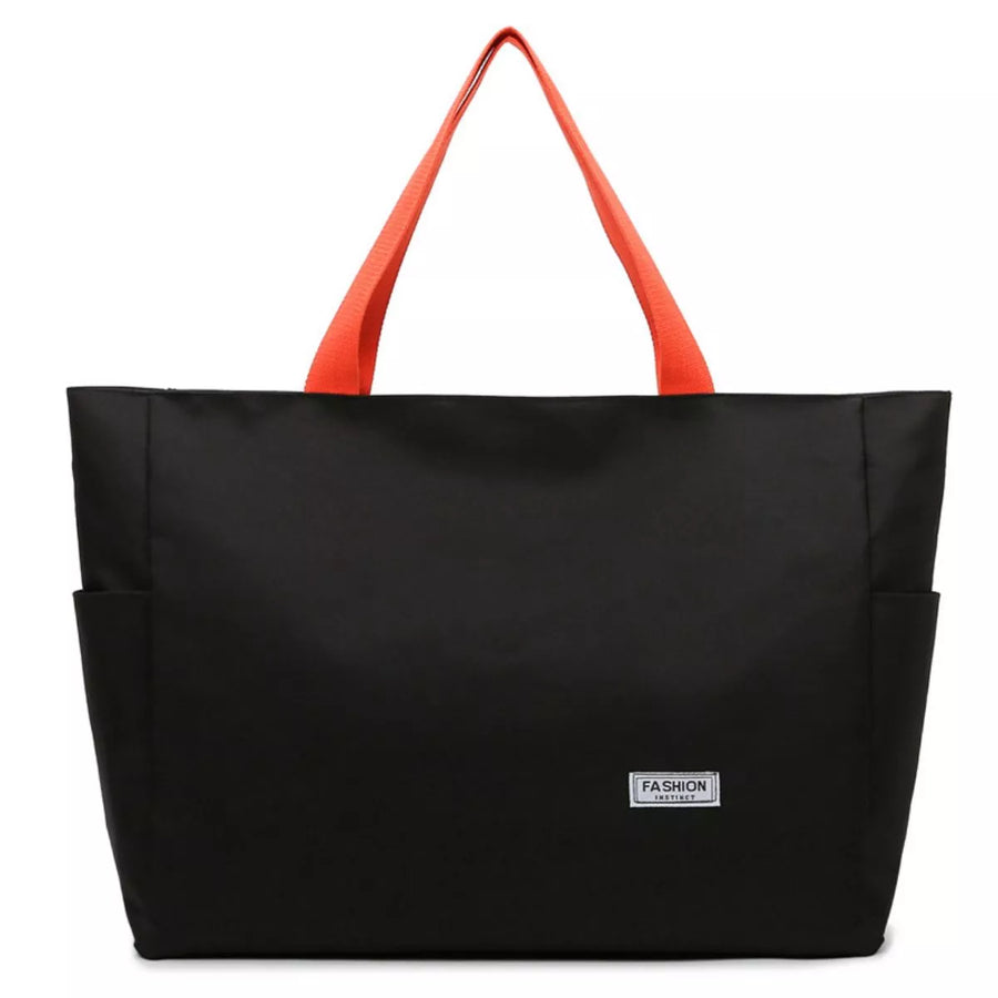 Black tote bag with orange handles on a white background