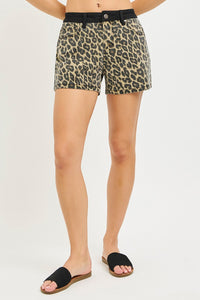 Animal print shorts worn by a person on a plain background