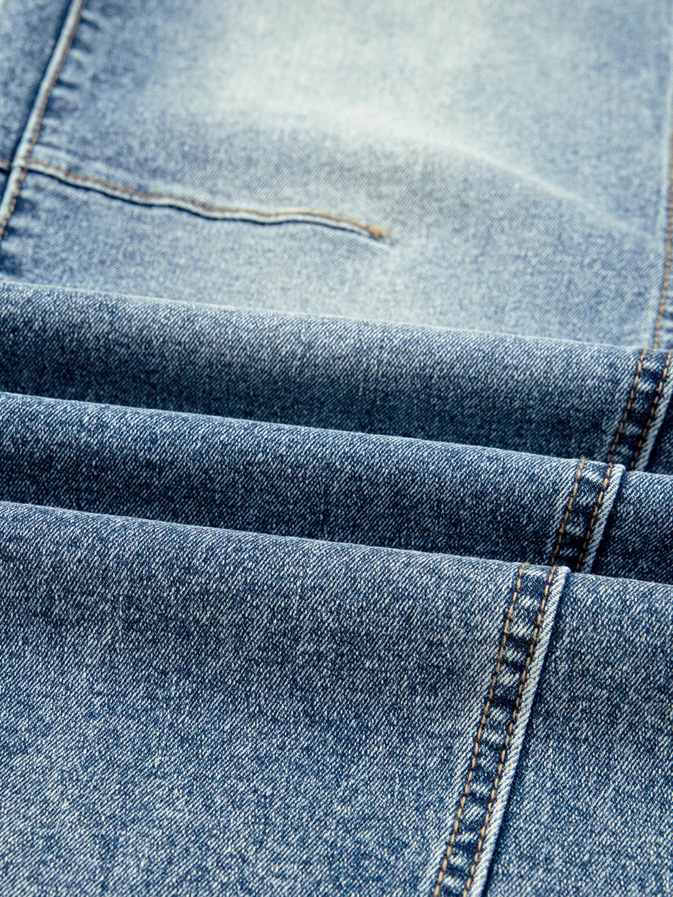 Close-up of blue denim fabric with stitching details