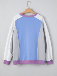 Color-blocked sweatshirt with blue and purple accents on a gray background