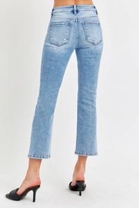 Light blue jeans worn by a person on a white background