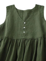 Green sleeveless dress with button details on a white background