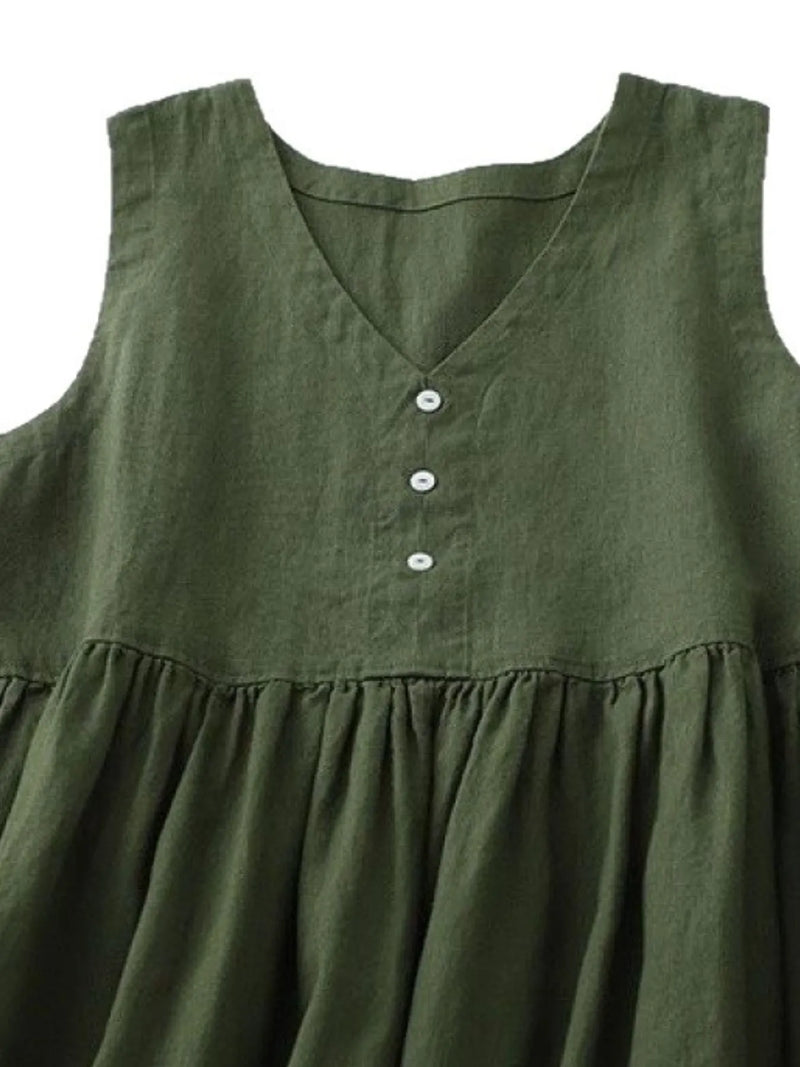 Green sleeveless dress with button details on a white background
