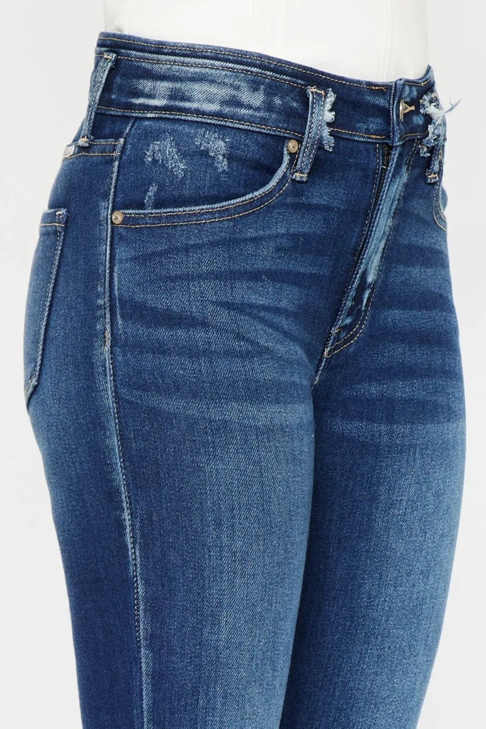 Close-up of blue jeans with a white background