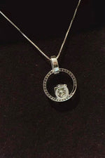 Silver necklace with a pendant on a dark background