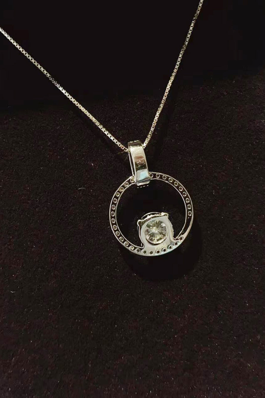 Silver necklace with a pendant on a dark background