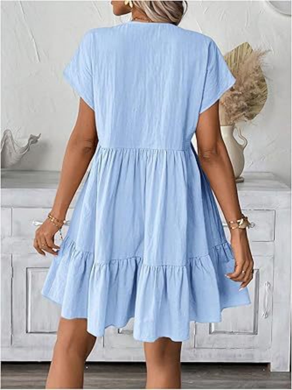 Light blue dress worn by a person in a neutral setting