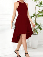 Woman wearing a burgundy dress with a white background and plant