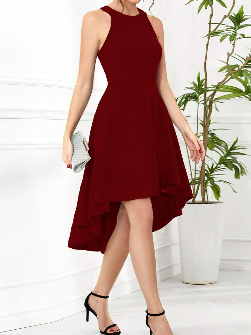 Woman wearing a burgundy dress with a white background and plant