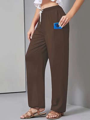Brown wide-leg pants worn by a person on a gray background