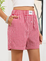 Red and white checkered shorts with 'Vogue' branding on a plain background
