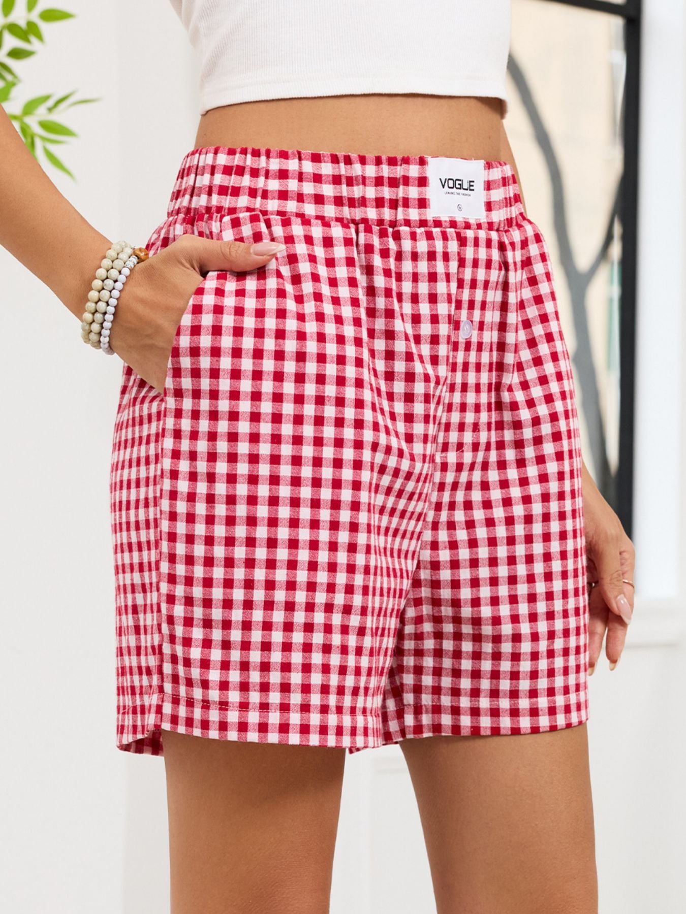Red and white checkered shorts with 'Vogue' branding on a plain background