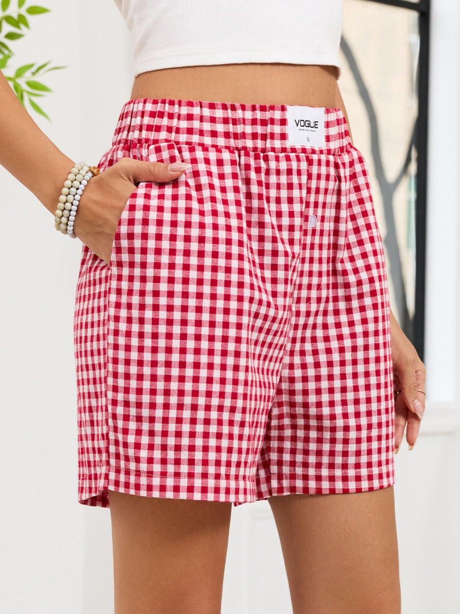 Red and white checkered shorts with 'Vogue' branding on a plain background