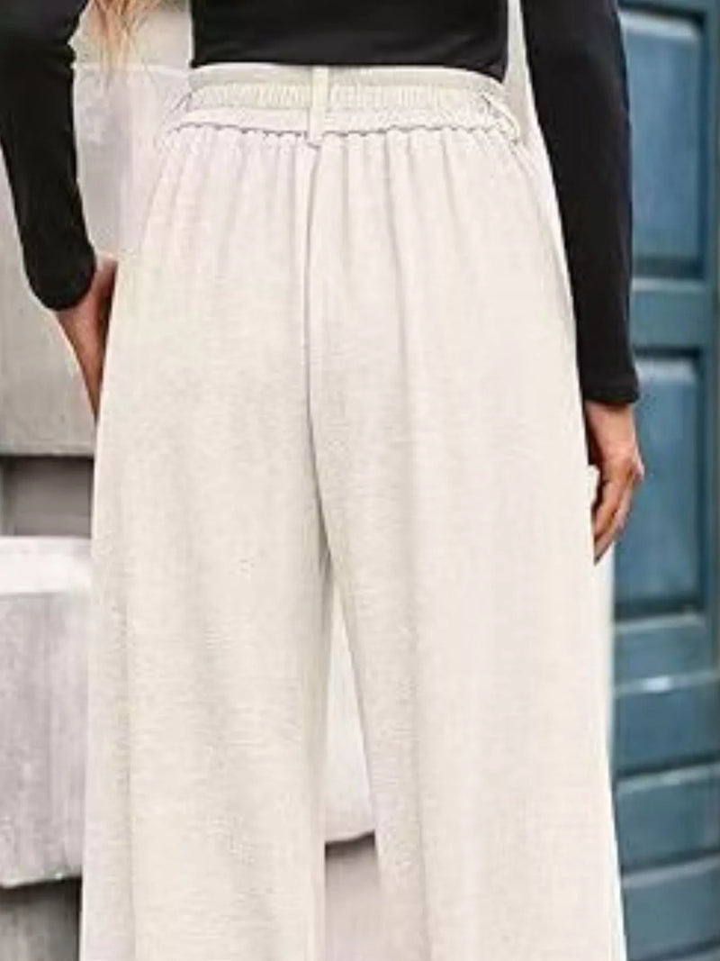 Person wearing beige pants with a blurred background