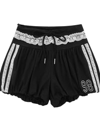 Black shorts with white lace waistband and stripes on a white background