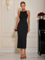 Woman in a black dress holding a glass of red wine in an elegant room.