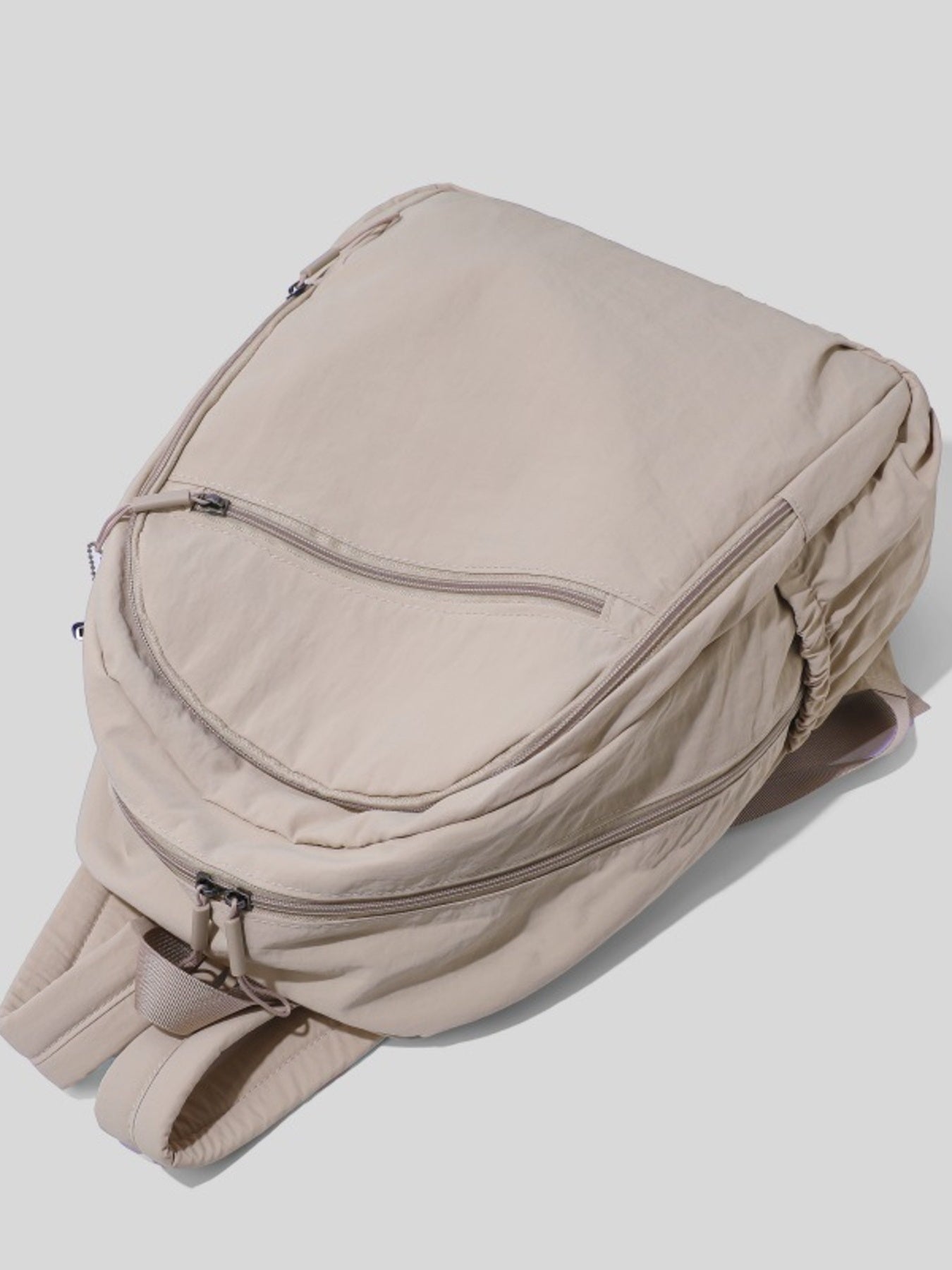 Beige backpack on a light gray background
