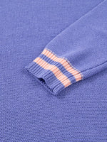 Close-up of a blue fabric with pink stitching detail