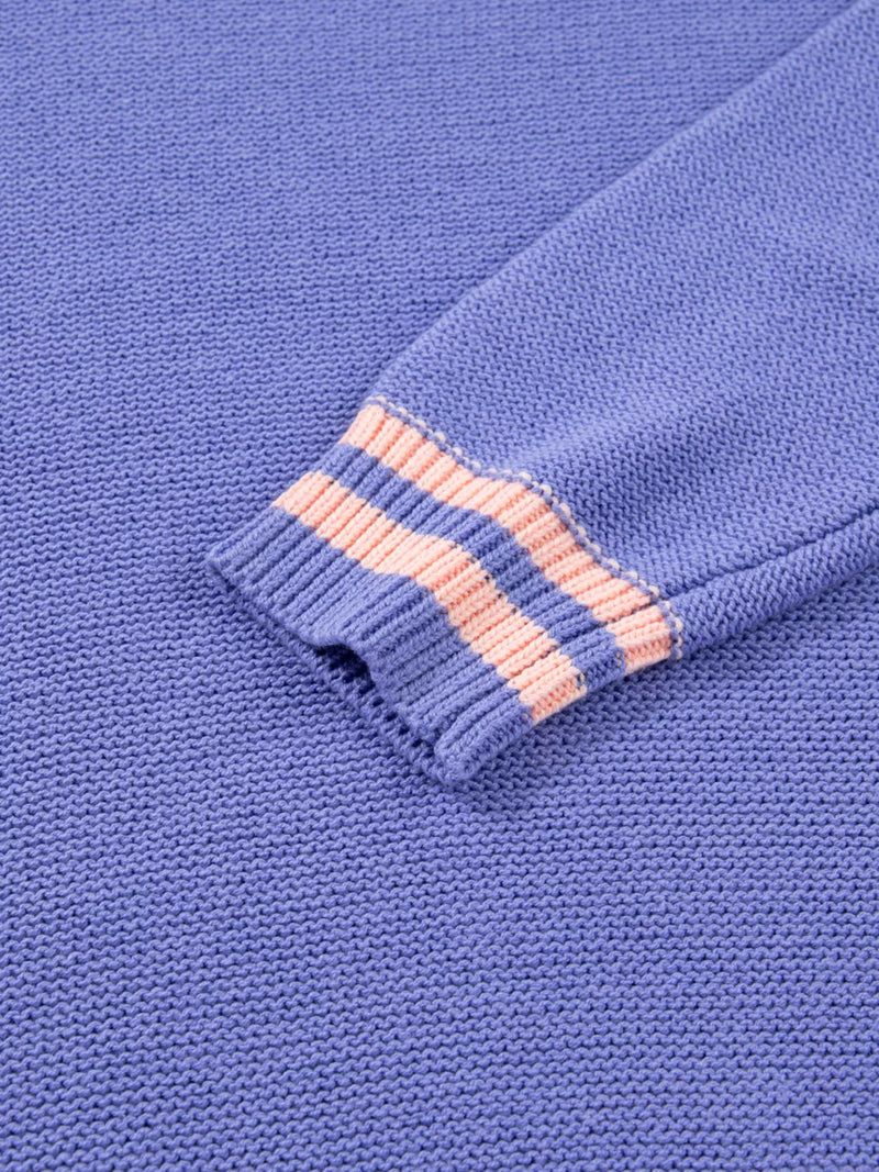 Close-up of a blue fabric with pink stitching detail