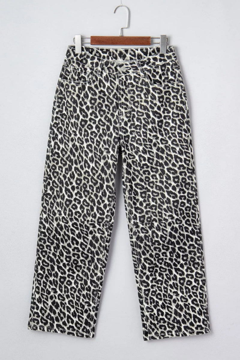 Leopard print pants on a hanger against a white background
