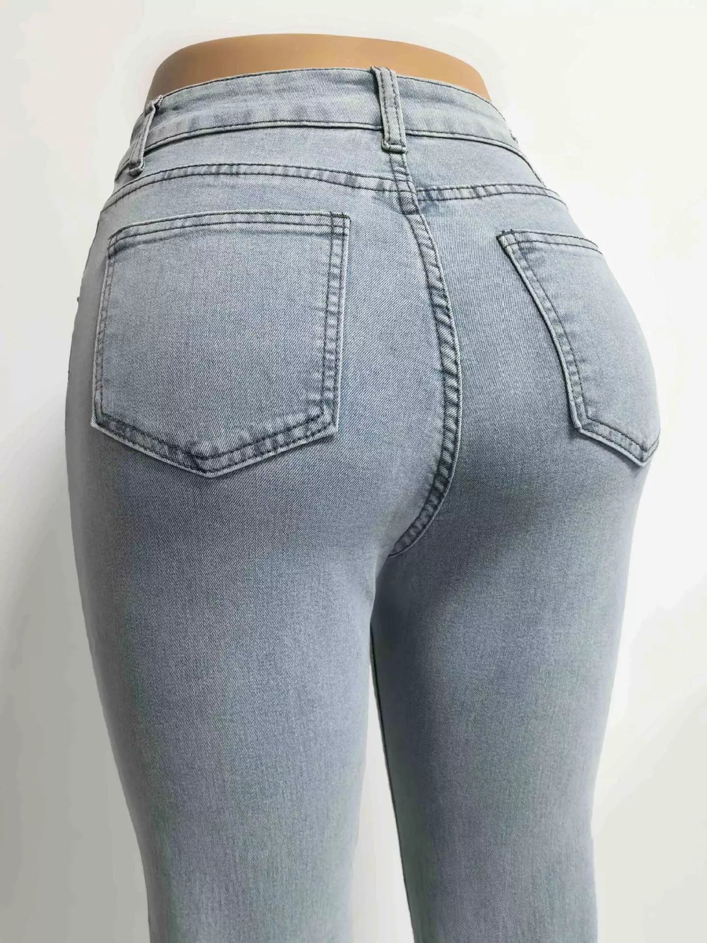 Light blue jeans on a plain background