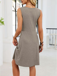 Woman wearing a gray dress in an indoor setting