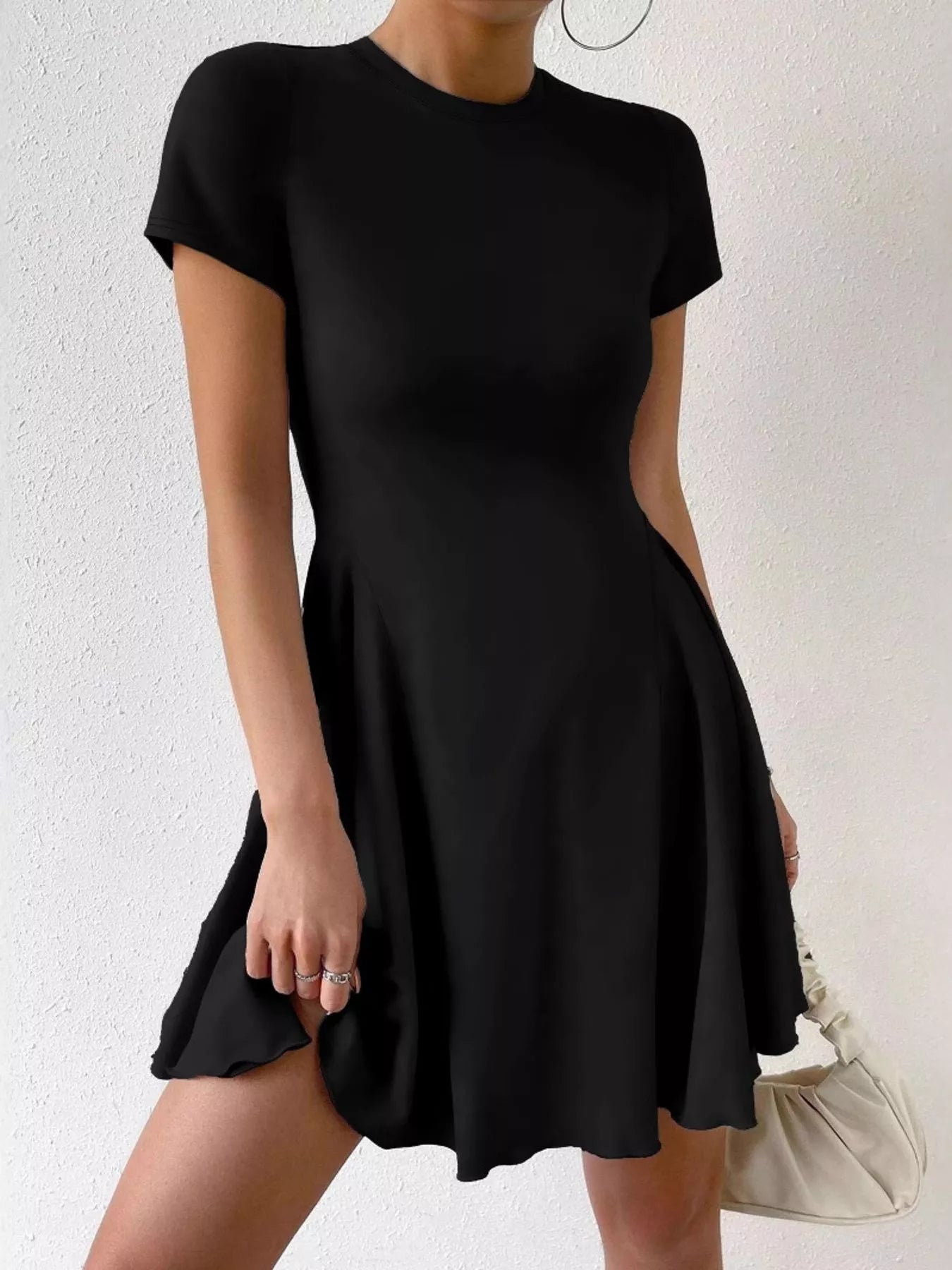 Black dress worn by a person on a white background
