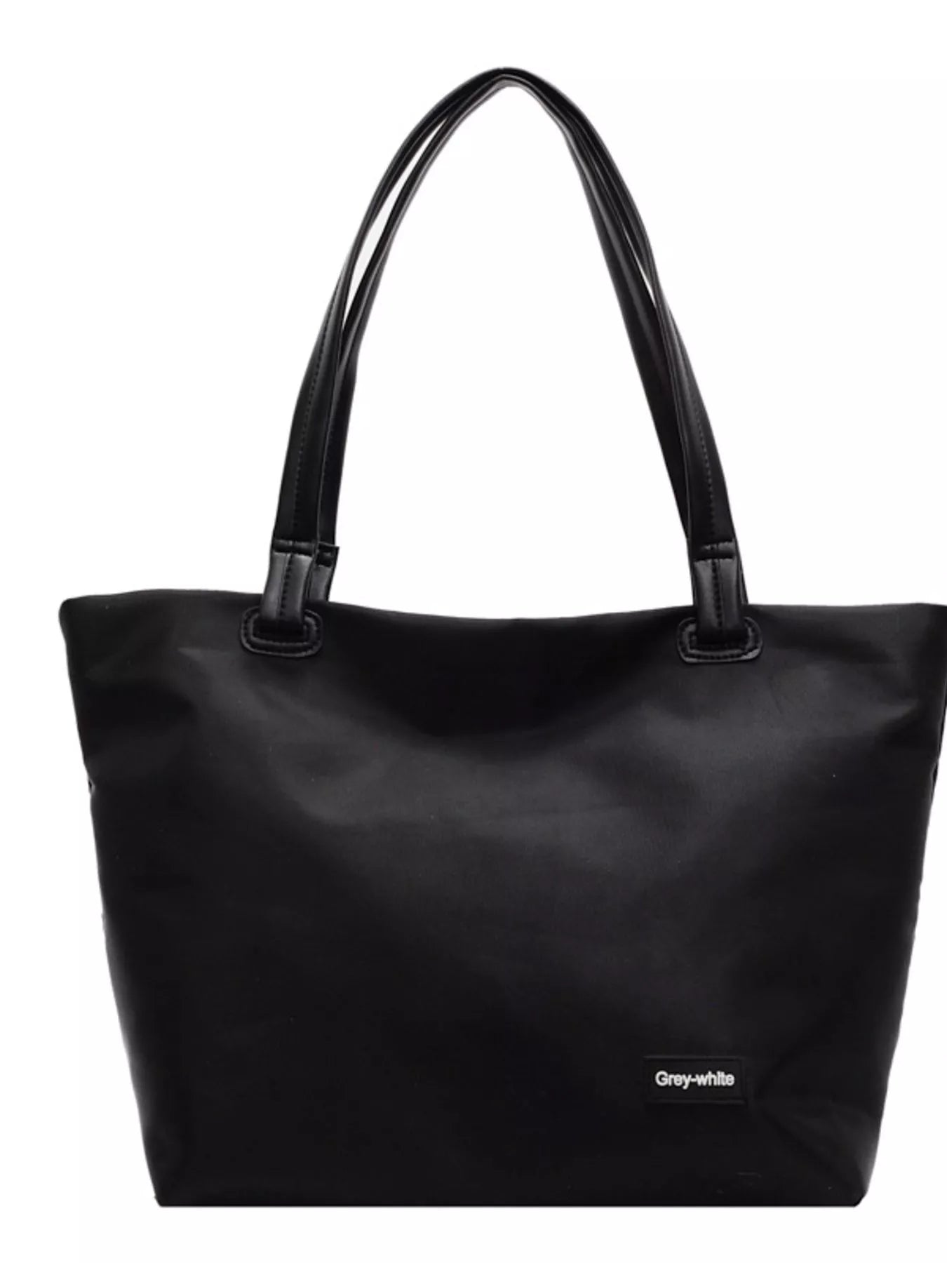 Black tote bag with a visible brand label on a white background