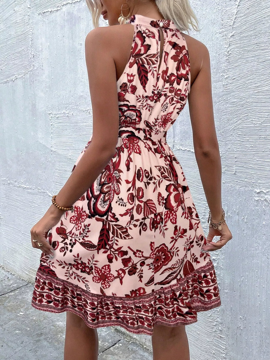 Woman wearing a floral dress against a textured wall.
