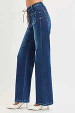Blue jeans worn by a person on a white background