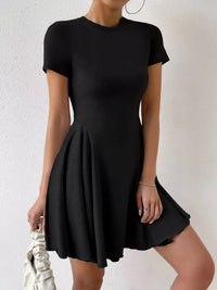 Black dress worn by a person on a white background